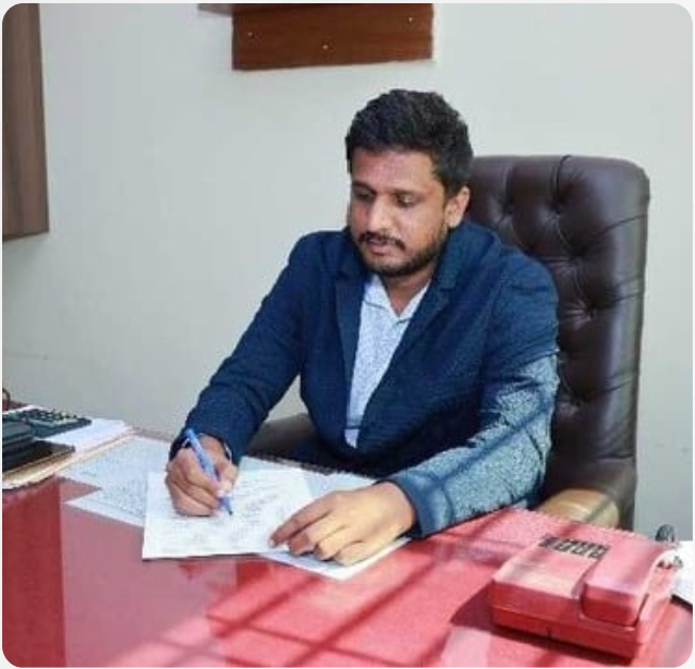 Head-and-shoulders portrait of Dr. Harish Patil, dean, wearing formal attire and smiling slightly; neutral light background; printed text reads Deans Message; professional and welcoming tone